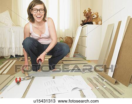 Woman building chest of drawers View Large Photo Image Stock Image - Woman building chest of drawers. Fotosearch