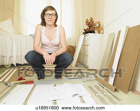 Woman building chest of drawers View Large Photo Image Stock Image - Woman building chest of drawers. Fotosearch