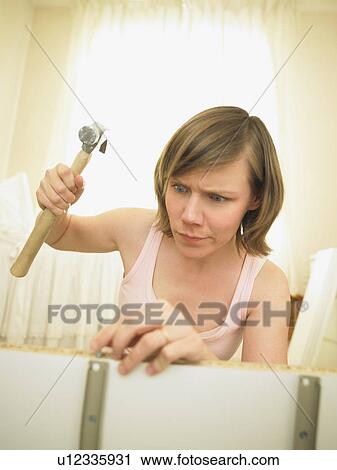Woman building furniture View Large Photo Image Stock Image - Woman building furniture. Fotosearch