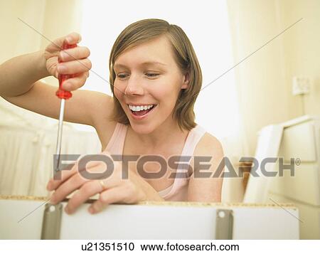 Woman building furniture View Large Photo Image Stock Image - Woman building furniture. Fotosearch