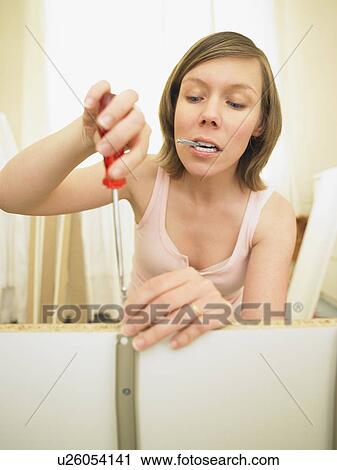Woman building furniture View Large Photo Image Stock Image - Woman building furniture. Fotosearch