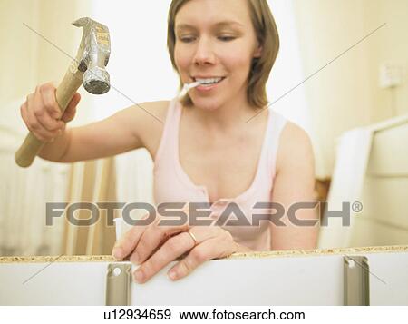 Woman building furniture View Large Photo Image Stock Photo - Woman building furniture. Fotosearch