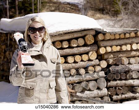 woman carrying skis by log pile View Large Photo Image Stock Photograph - woman carrying skis by log pile. Fotosearch