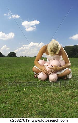 woman clutching piggy banks View Large Photo Image Stock Photo - woman clutching piggy banks. Fotosearch