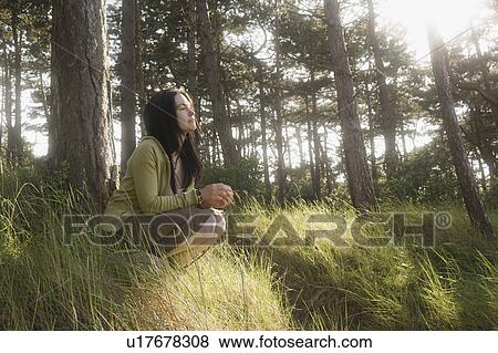 Stock Photo - Woman crouching in contemplation. Fotosearch