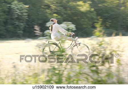 Woman cycling through countryside View Large Photo Image Stock Photo - Woman cycling through countryside. Fotosearch