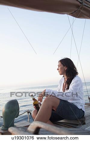 woman drinking beer watching sunset View Large Photo Image Stock Photograph - woman drinking beer watching sunset. Fotosearch