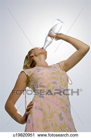 woman drinking water from bottle View Large Photo Image Stock Image - woman drinking water from bottle. Fotosearch