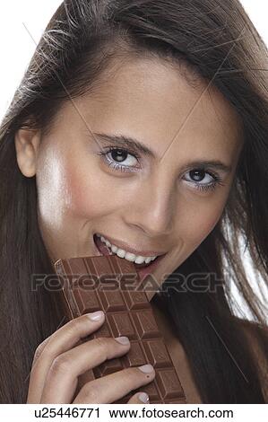 Woman eating chocolate View Large Photo Image Stock Image - Woman eating chocolate. Fotosearch