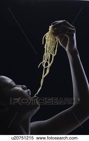 Woman eating noodles with her hands View Large Photo Image Stock Photography - Woman eating noodles with her hands. Fotosearch