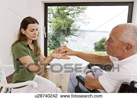 woman handing medicine to man View Large Photo Image Stock Image - woman handing medicine to man. Fotosearch