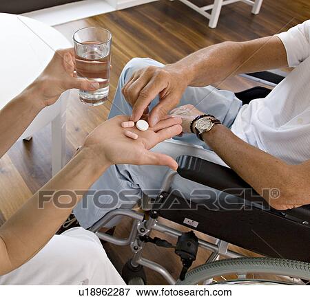 woman handing medicine to man View Large Photo Image Stock Photo - woman handing medicine to man. Fotosearch