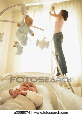 Woman hanging curtains View Large Photo Image Stock Image - Woman hanging curtains. Fotosearch