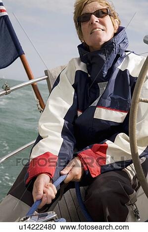Woman hoisting sails on yacht View Large Photo Image Stock Image - Woman hoisting sails on yacht. Fotosearch