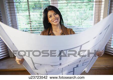 Woman holding a blue print View Large Photo Image Stock Image - Woman holding a blue print. Fotosearch
