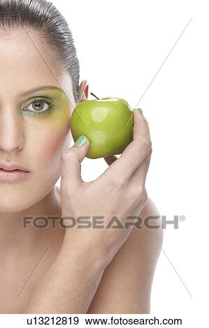 Woman holding green apple View Large Photo Image Stock Photo - Woman holding green apple. Fotosearch