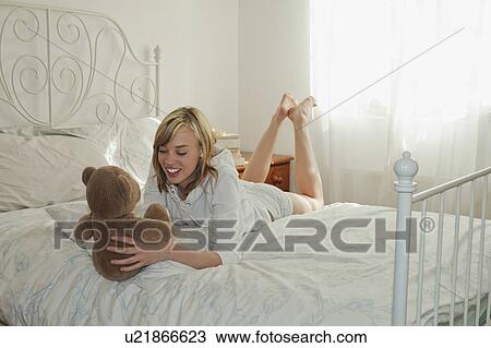 Stock Image - Woman holding teddy bear. Fotosearch