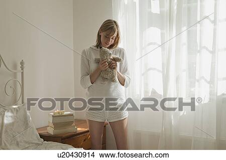 Picture - Woman hugging teddy bear. Fotosearch
