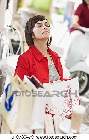 woman in a street cafe after shopping View Large Photo Image Stock Photo - woman in a street cafe after shopping. Fotosearch