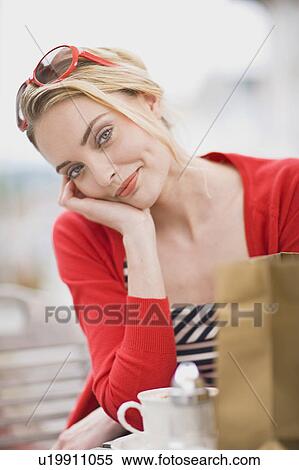 Stock Photography - woman in a street cafe glancing at you. Fotosearch