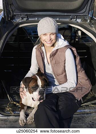woman in back of car with dog View Large Photo Image Picture - woman in back of car with dog. Fotosearch