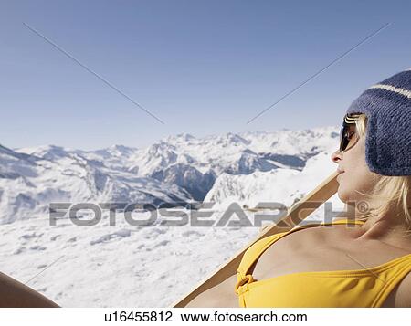 Stock Image - woman in bikini on on deck chair. Fotosearch