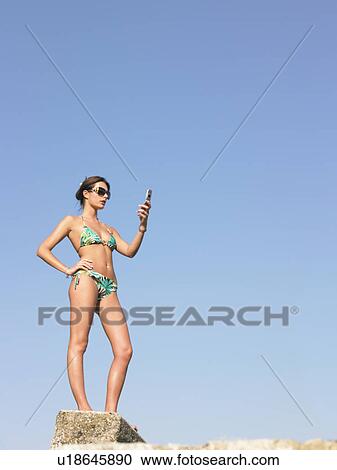 woman in bikini using phone View Large Photo Image Stock Image - woman in bikini using phone. Fotosearch