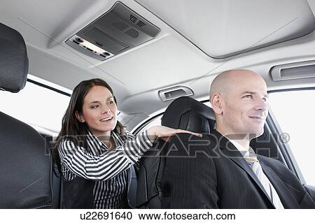 Stock Image - woman in car talking to driver. Fotosearch