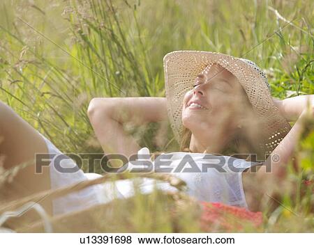 Stock Photo - woman in hat eyes closed, relaxed. Fotosearch