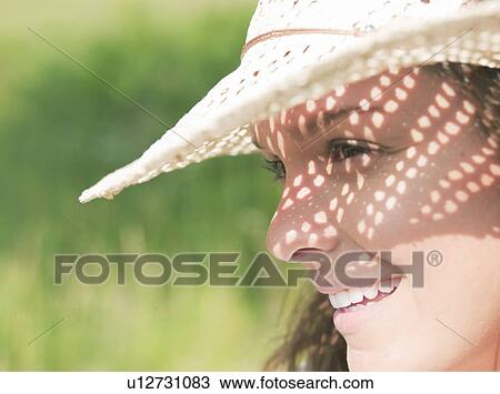 Woman in sun hat in sunshine View Large Photo Image Stock Image - Woman in sun hat in sunshine. Fotosearch