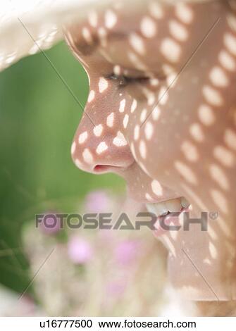 Stock Image - Woman in sun hat in sunshine. Fotosearch