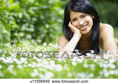Stock Photo - Woman in the daisies, smiling. Fotosearch