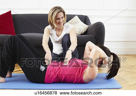 Woman instructing a client. Pilates. View Large Photo Image Stock Photo - Woman instructing a client. Pilates.. Fotosearch