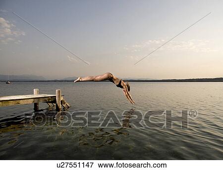 woman jumping from pier View Large Photo Image Stock Photo - woman jumping from pier. Fotosearch