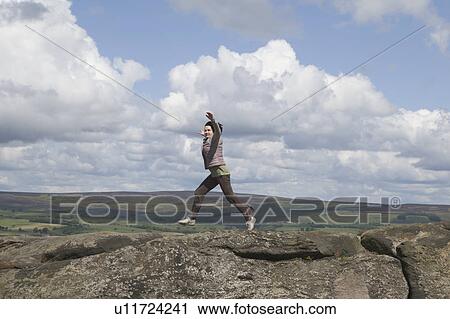 Woman jumping on rock View Large Photo Image Stock Image - Woman jumping on rock. Fotosearch