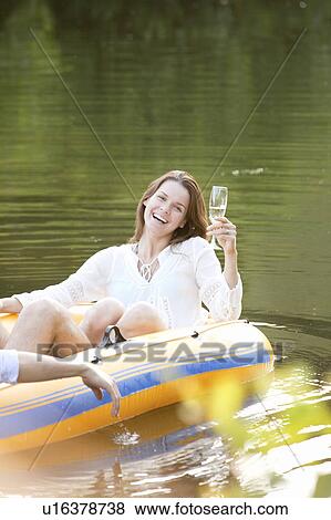 Woman laughing in dinghy in lake View Large Photo Image Stock Photo - Woman laughing in dinghy in lake. Fotosearch