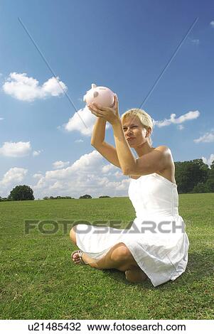 woman looking at piggy bank View Large Photo Image Stock Image - woman looking at piggy bank. Fotosearch
