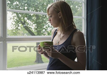 Woman looking out of window View Large Photo Image Stock Photo - Woman looking out of window. Fotosearch