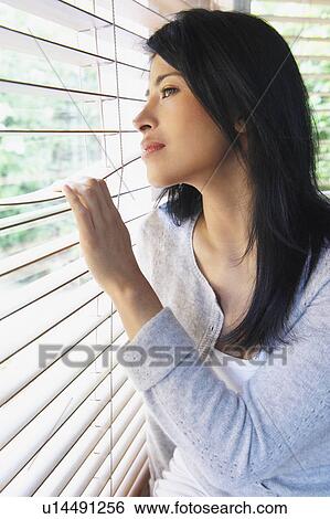 Woman looking through window View Large Photo Image Stock Photograph - Woman looking through window. Fotosearch