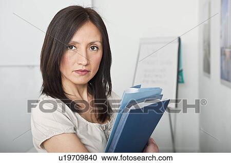 woman looking to camera holding files View Large Photo Image Stock Image - woman looking to camera holding files. Fotosearch