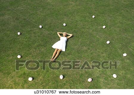 woman lying amongst piggy banks View Large Photo Image Stock Photo - woman lying amongst piggy banks. Fotosearch