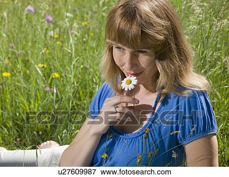 woman lying in grass with spring flowers View Large Photo Image Stock Photo - woman lying in grass with spring flowers. Fotosearch