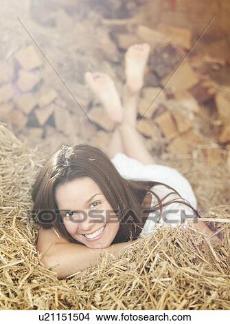 Woman lying in hay View Large Photo Image Picture - Woman lying in hay. Fotosearch