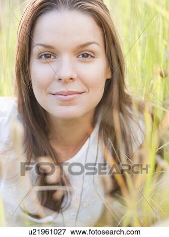 Woman lying in long grass View Large Photo Image Stock Photo - Woman lying in long grass. Fotosearch