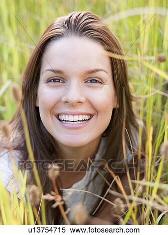 Woman lying in long grass View Large Photo Image Stock Photography - Woman lying in long grass. Fotosearch