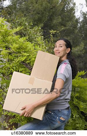 Stock Photo - woman moving in a new house. Fotosearch