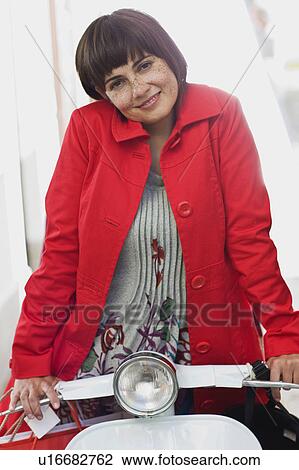 Stock Image - woman on a motor scooter. Fotosearch