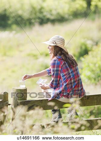 Woman on gate painting picture View Large Photo Image Stock Photograph - Woman on gate painting picture. Fotosearch