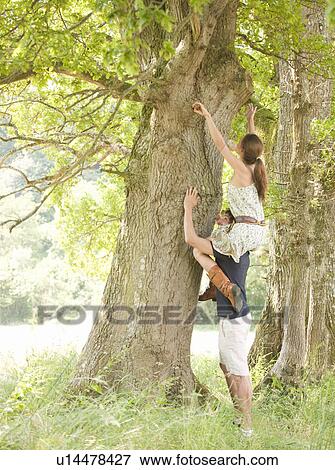 woman on mans shoulders under tree View Large Photo Image Stock Photo - woman on mans shoulders under tree. Fotosearch