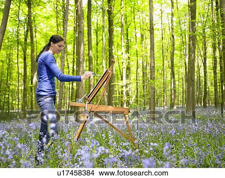 Woman painting in the forest View Large Photo Image Picture - Woman painting in the forest. Fotosearch